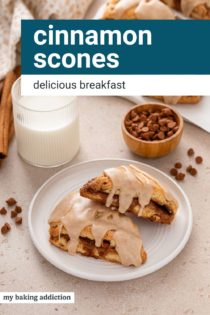 Two cinnamon scones arranged on a white plate in front of a glass of milk. Text overlay includes recipe name.