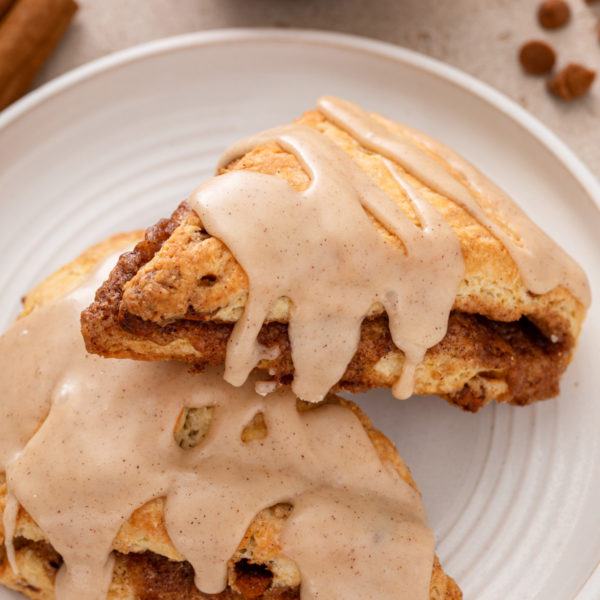 Close up of cinnamon scones on a white plate.