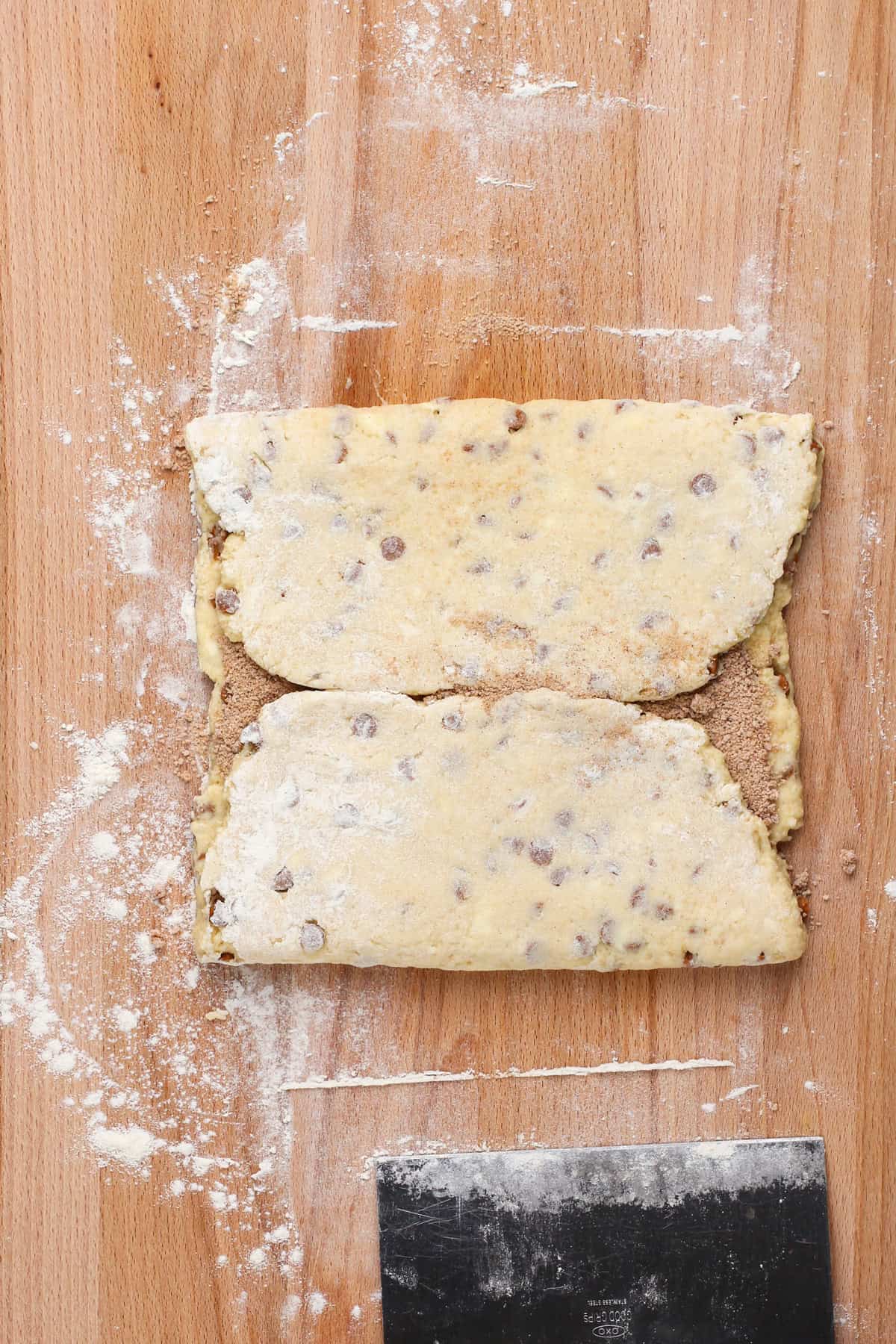 Scone dough folded into a square over cinnamon-sugar filling.