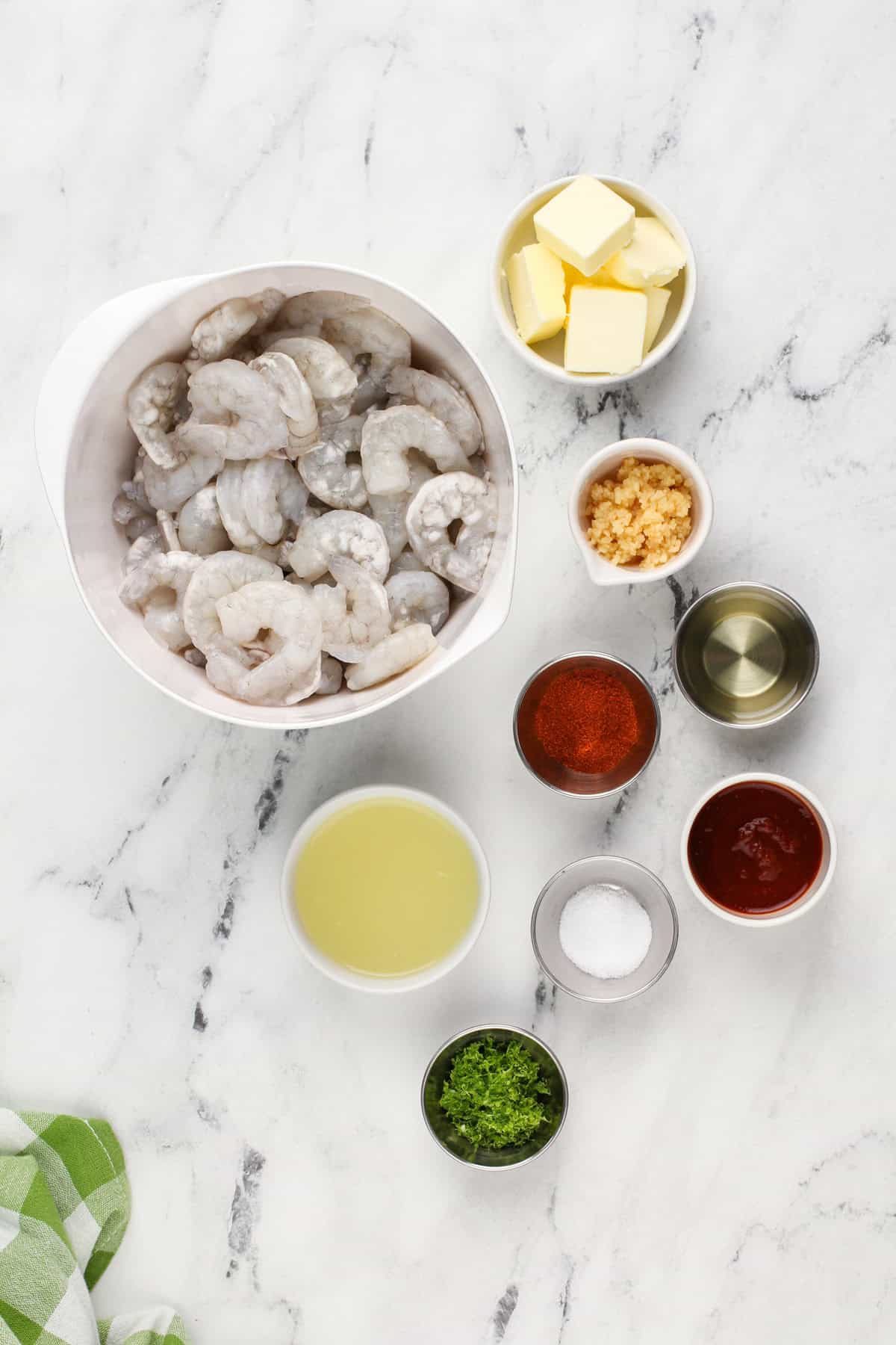 Marinated shrimp taco ingredients arranged on a marble countertop.