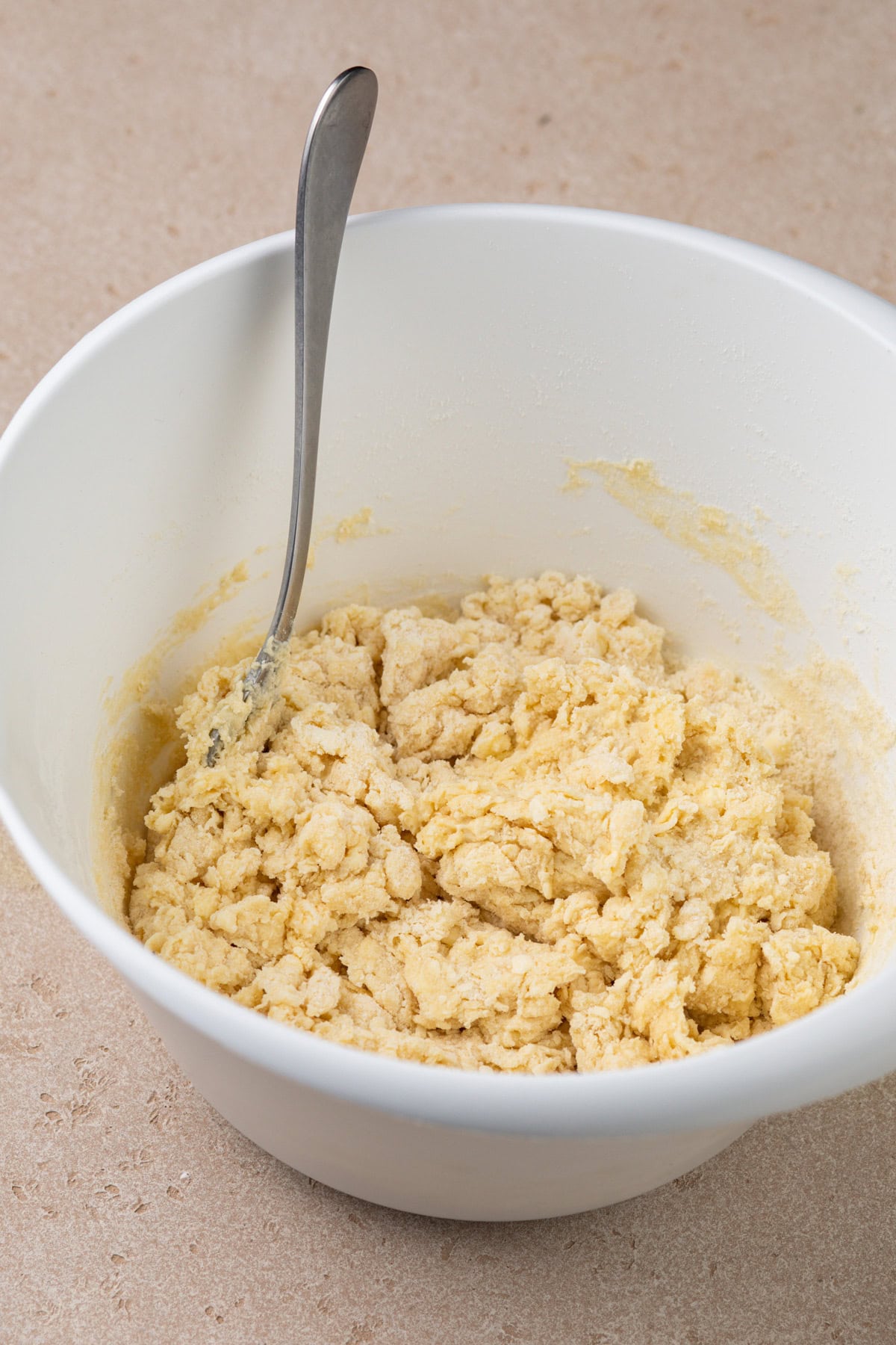 Fork stirring scone dough together.