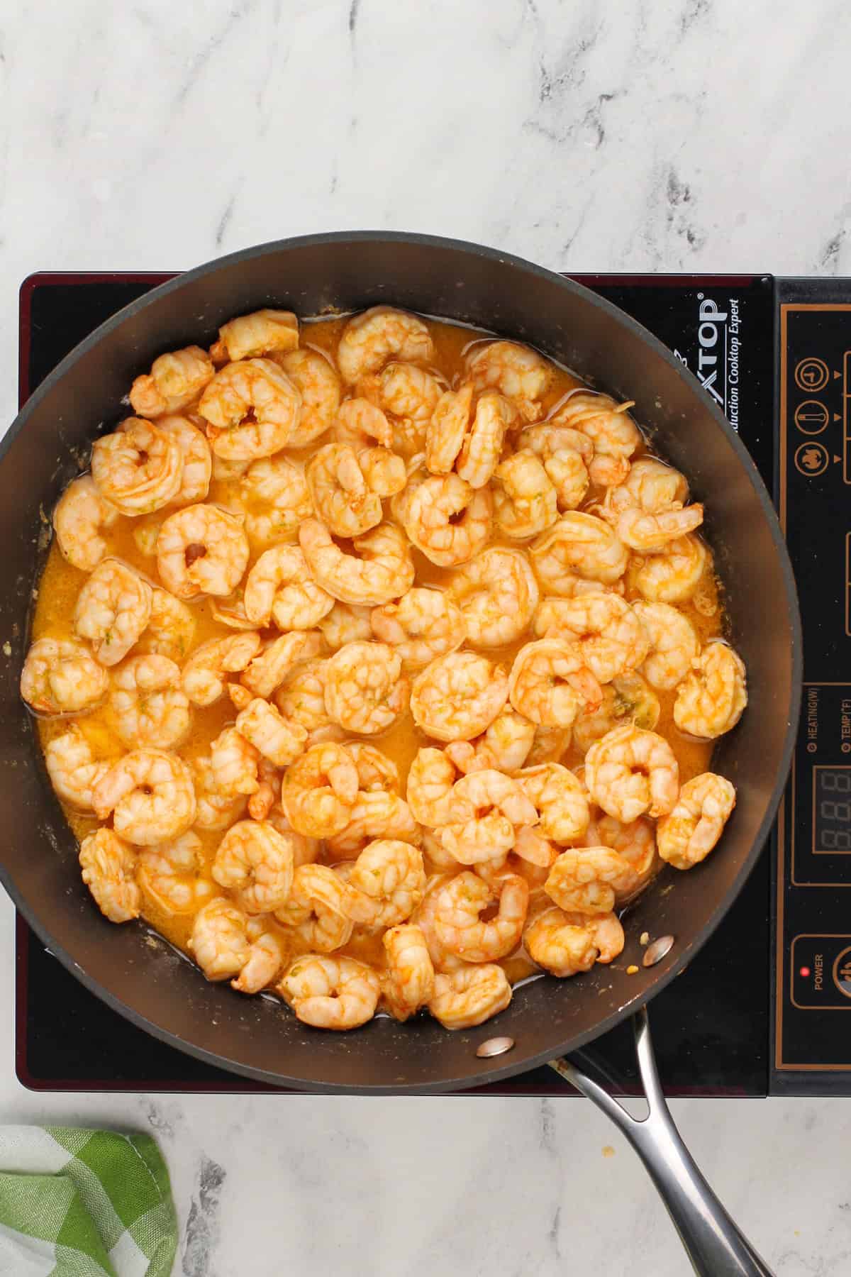 Cooked shrimp for tacos in a skillet.