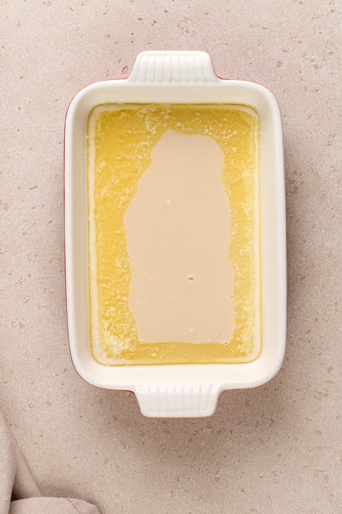 Geschmolzene Butter auf dem Boden einer weißen Auflaufform.