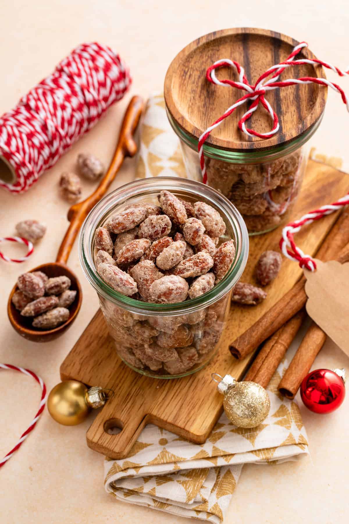 Candied almonds in glass jars with gift tags for the holidays.