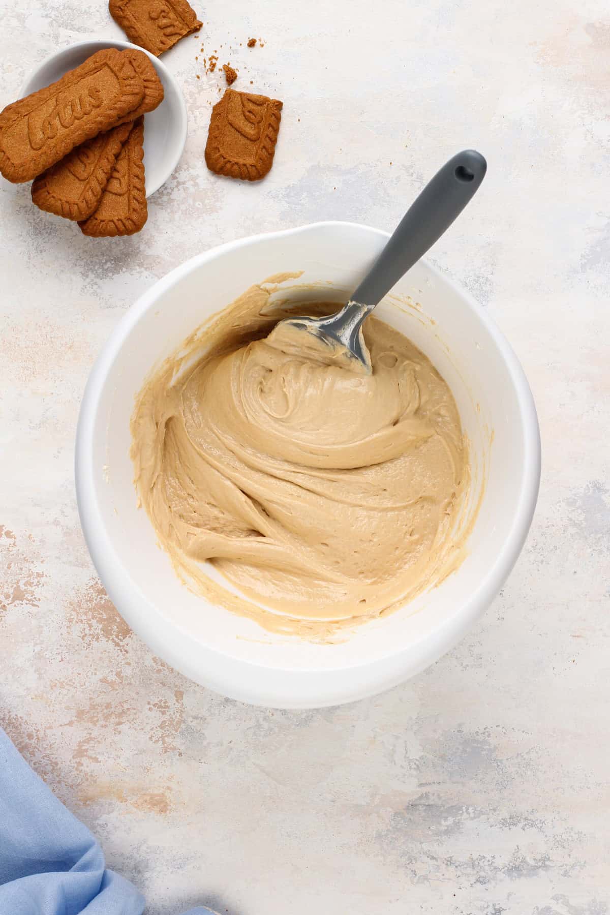 Biscoff cheesecake filling mixed in a white bowl.