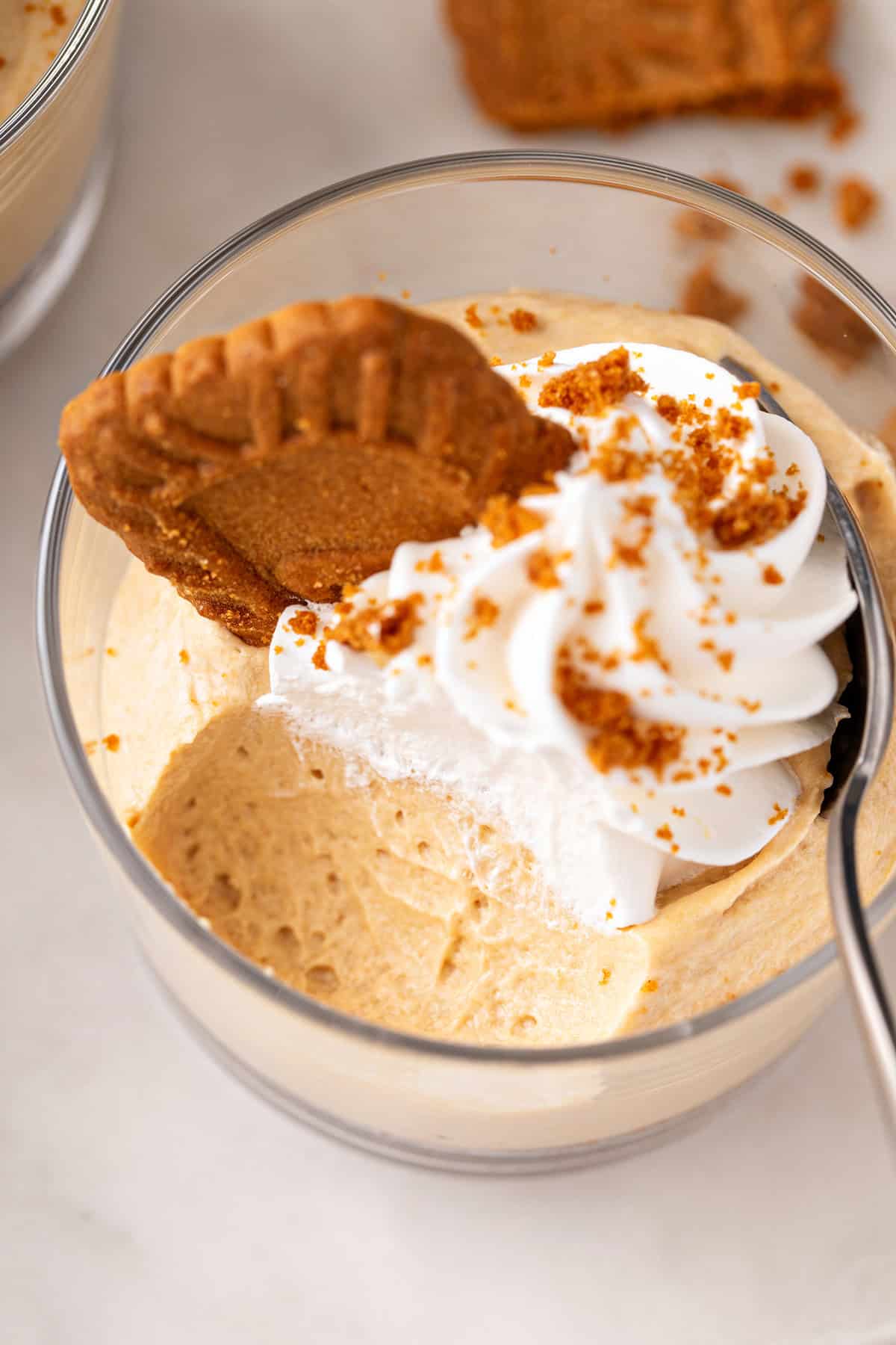 Bake taken from no-bake biscoff cheesecake in a glass ramekin.