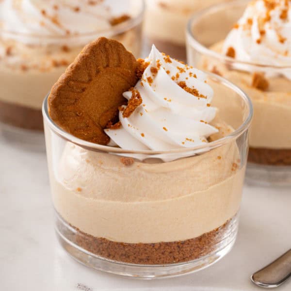 Close up of no-bake biscoff cheesecake in a glass ramekin.