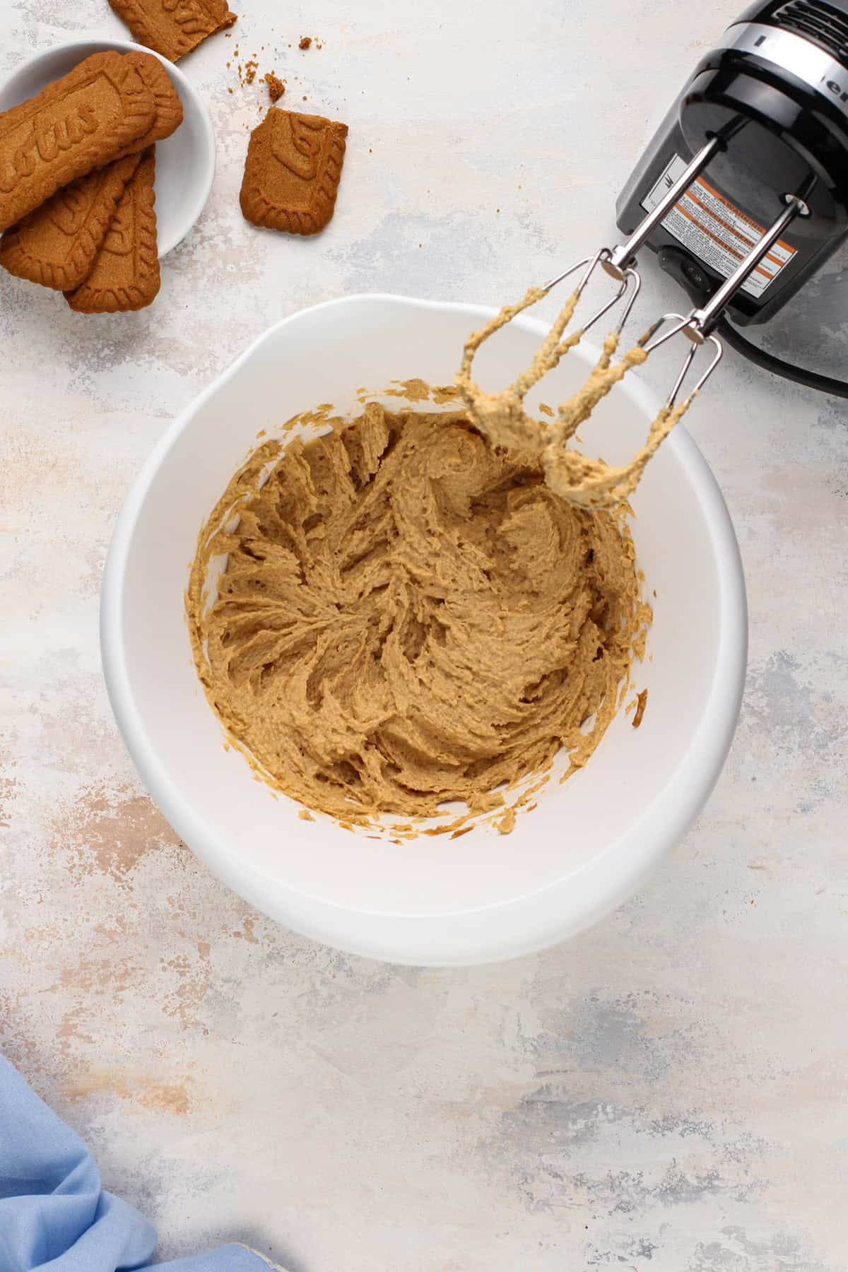 Cream cheese and biscoff spread mixed in a white bowl.