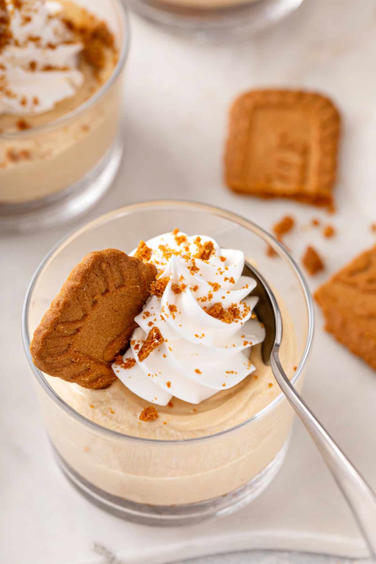 Spoon in a ramekin of no-bake biscoff cheesecake.