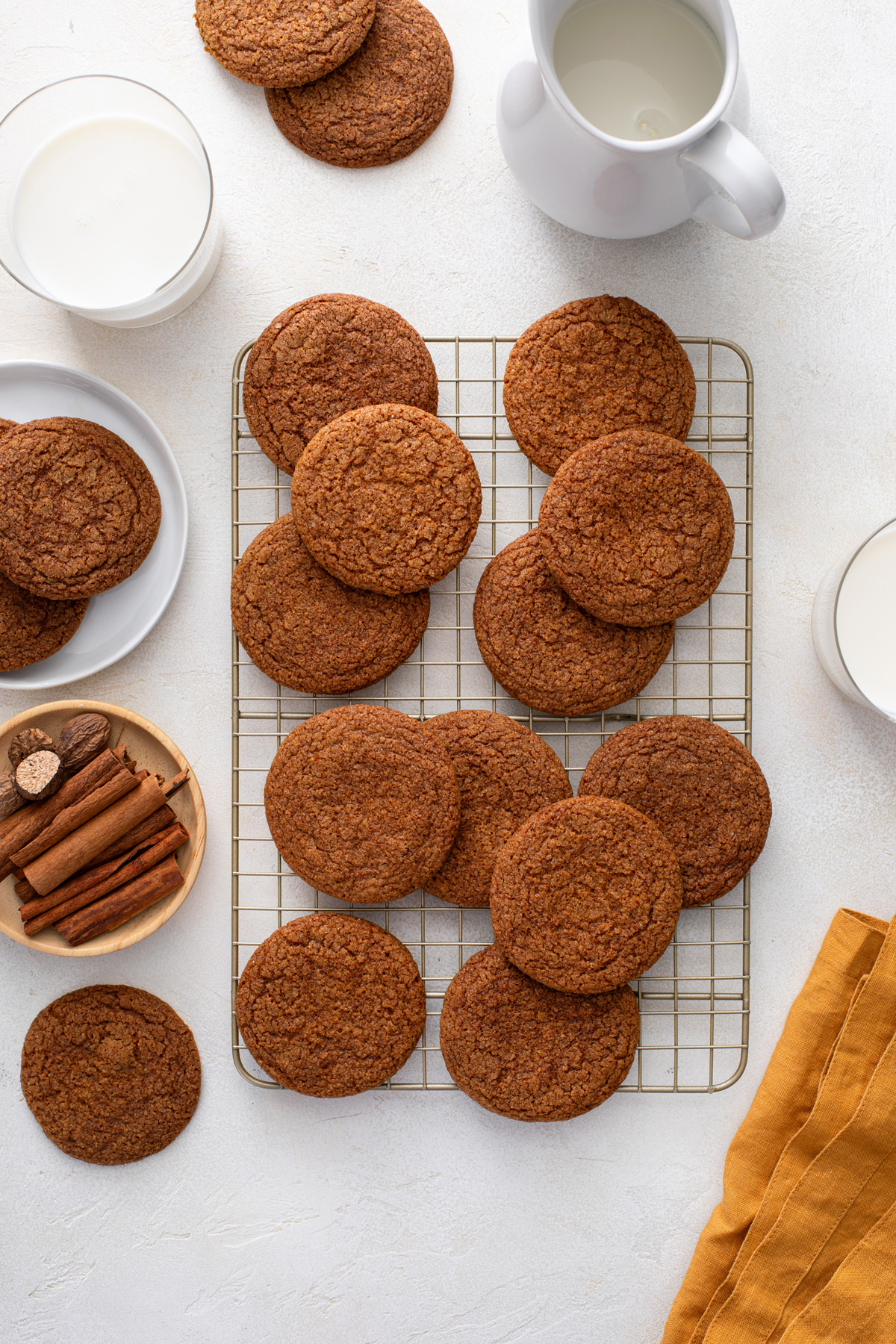 Overhead view of molasses cookies cooling on a wire rack.