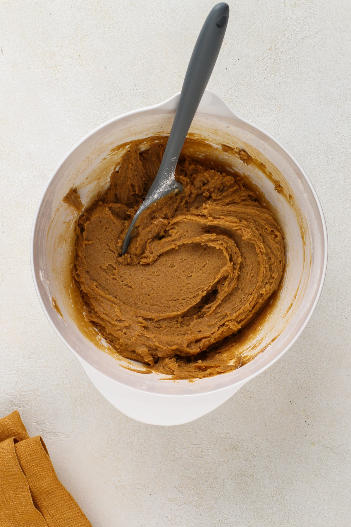 Molasses cookie dough in a white bowl.