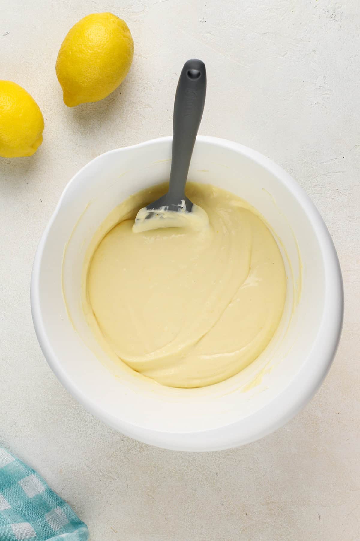 Mini lemon cheesecake filling in a white mixing bowl.