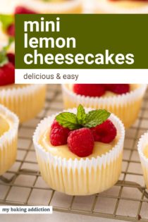 Mini lemon cheesecakes topped with lemon curd and fresh raspberries on a wire rack. Text overlay includes recipe name.