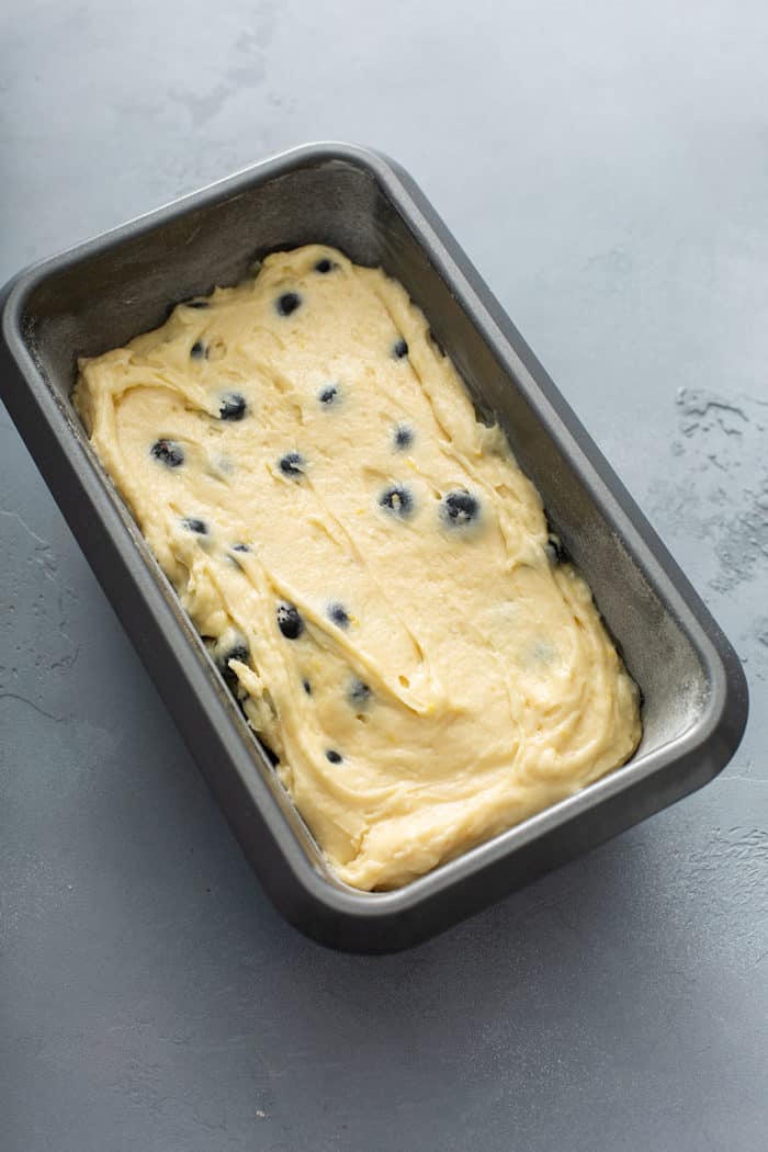 Lemon blueberry bread batter in a loaf pan, ready to be baked