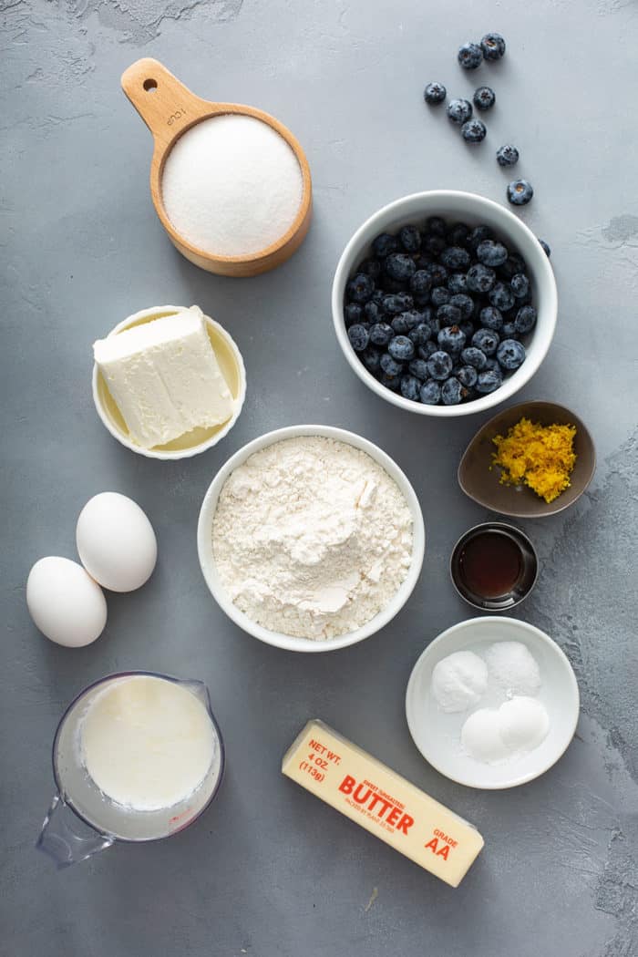 Ingredients for lemon blueberry bread on a gray counter