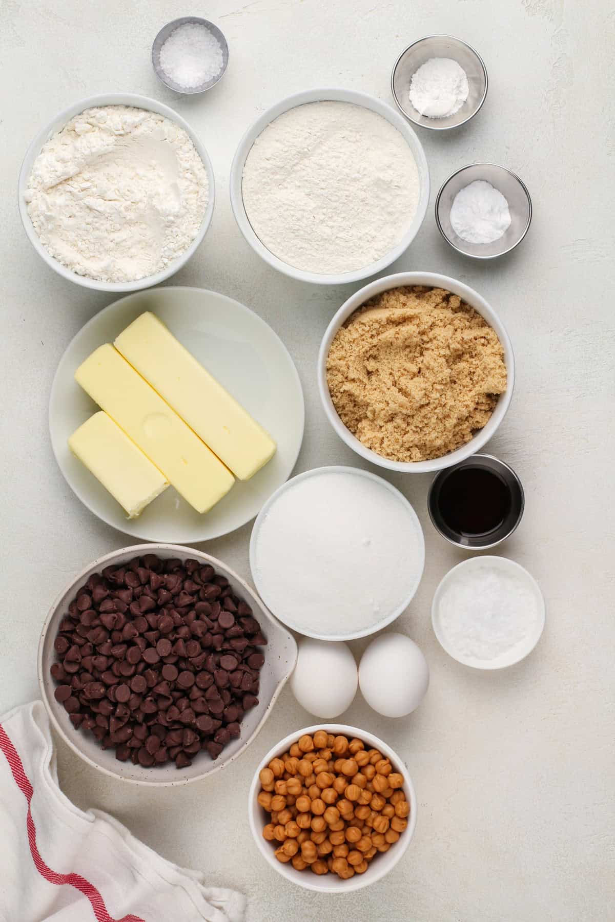 Ingredients for salted caramel chocolate chip cookies arranged on a countertop.
