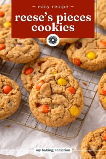 Reese's pieces cookies scattered on a wire cooling rack. Text overlay includes recipe name.