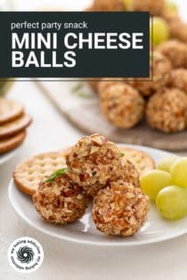 Several mini cheese balls next to grapes and crackers on a white plate. Text overlay includes recipe name.