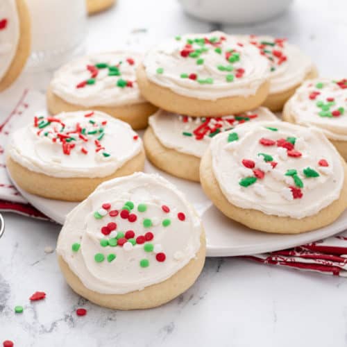 Sour cream sugar cookies on a white platter.