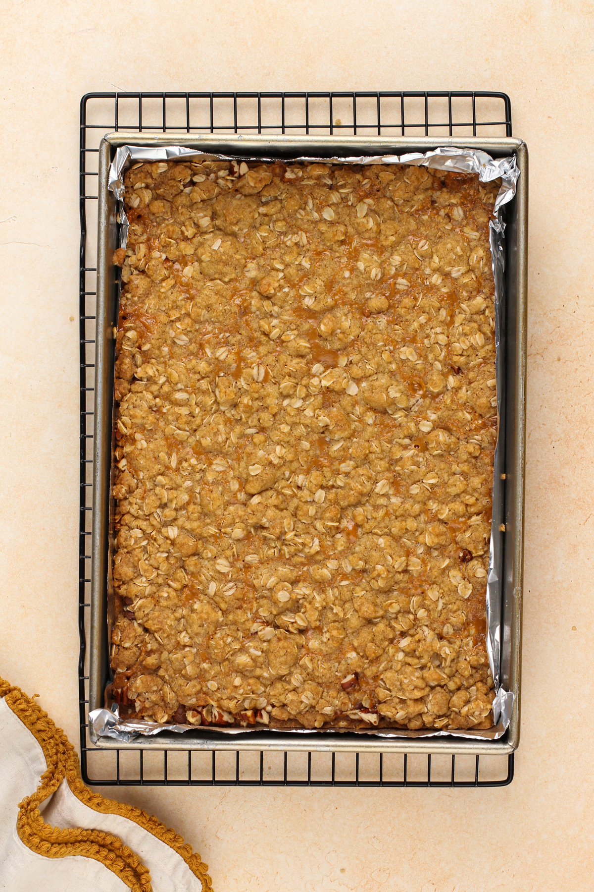 Baked caramel pecan bars cooling in a 9x13-inch pan.