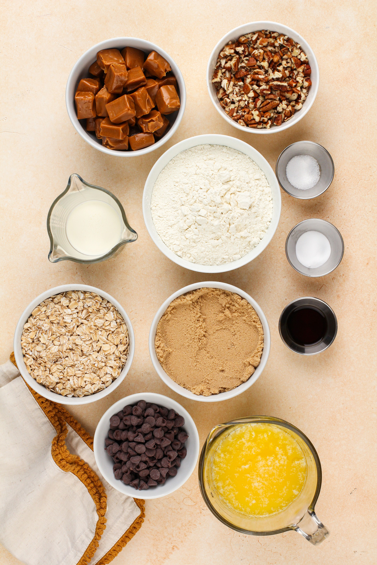 Caramel pecan bar ingredients arranged on a countertop.