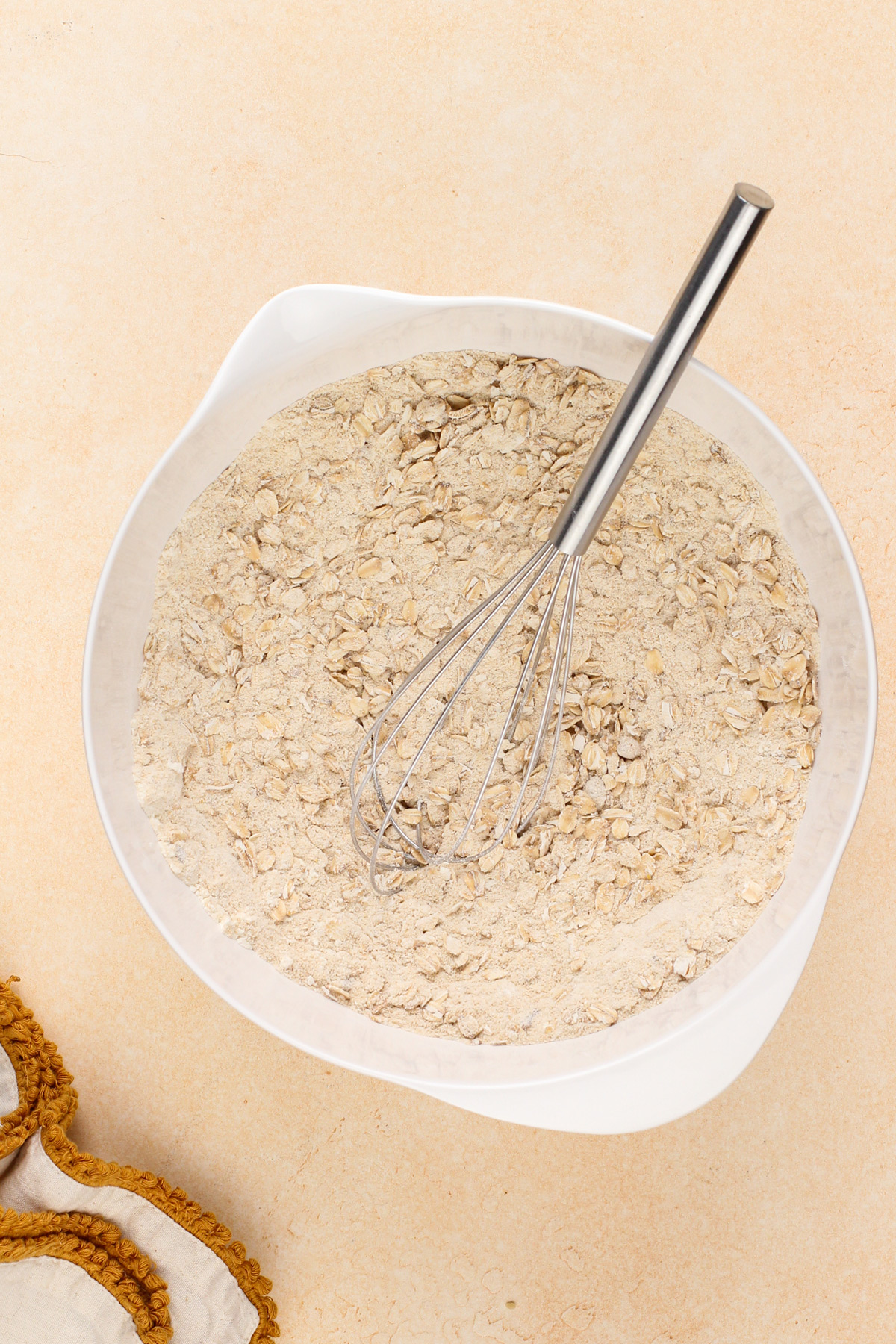 Dry ingredients for caramel pecan bars whisked together in a bowl.