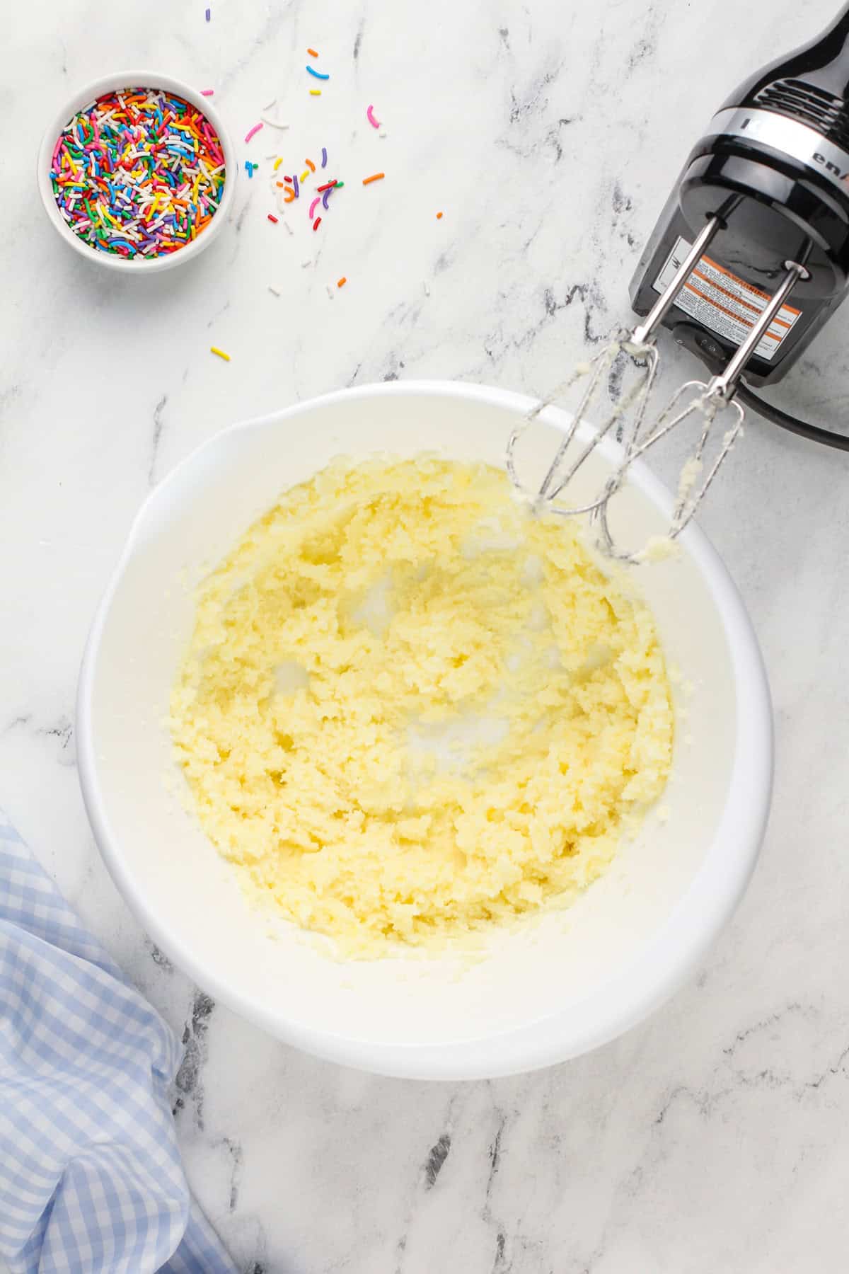 Creamed butter and sugar in a white mixing bowl.