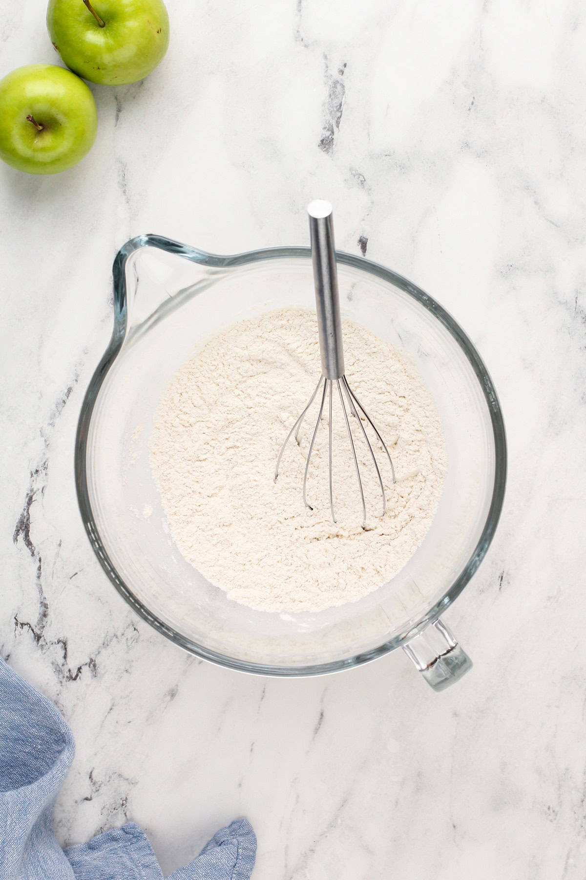 Dry ingredients for yeast dough in a glass mixing bowl.