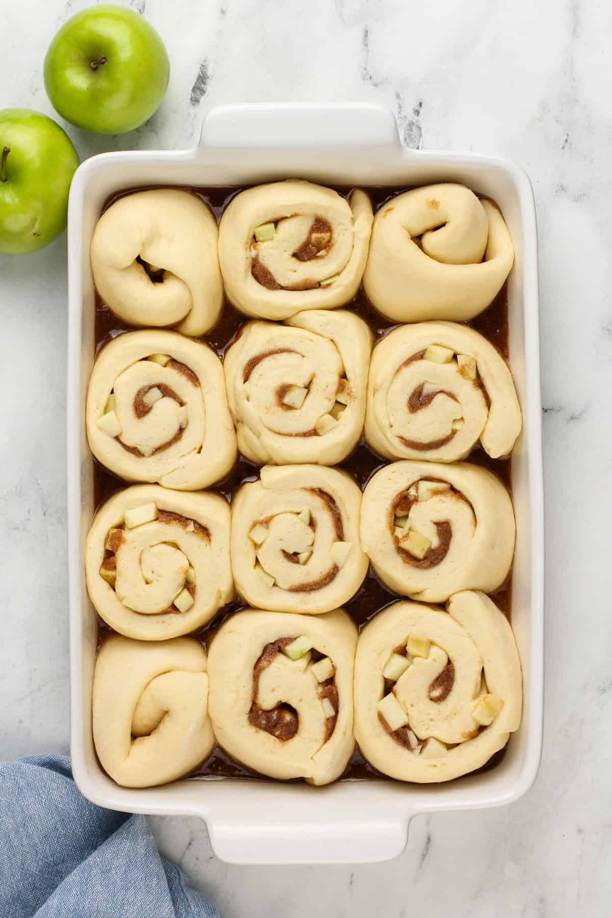 Risen caramel apple cinnamon rolls, ready to go in the oven.