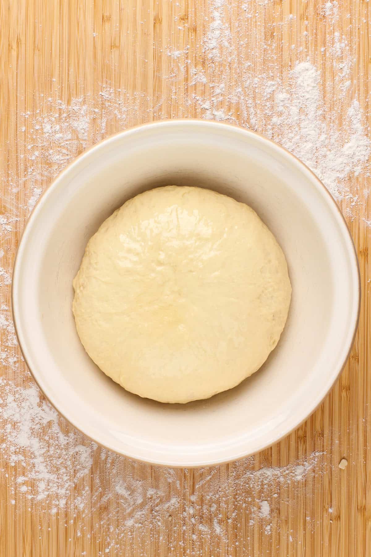 Kneaded yeast dough in a ceramic bowl.