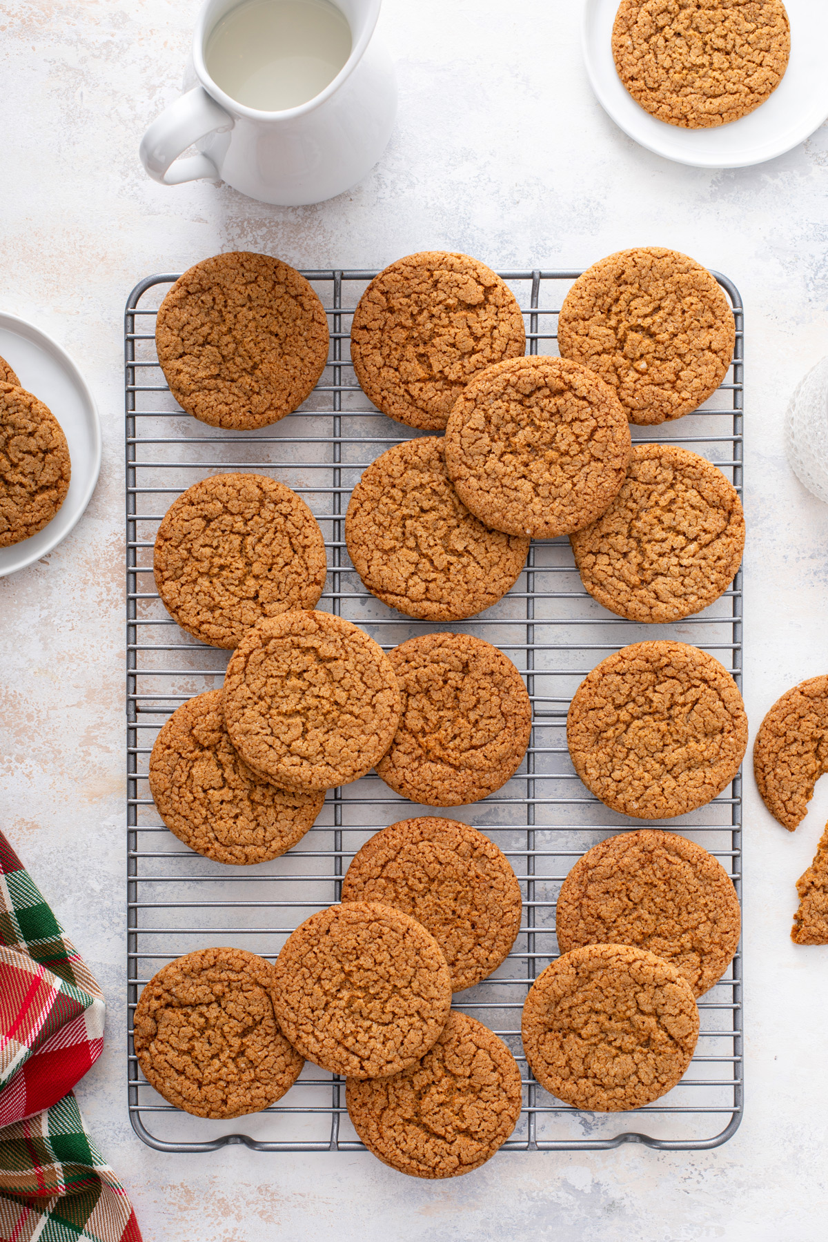 Gingersnap cookies arranged on a wire cooling rack.