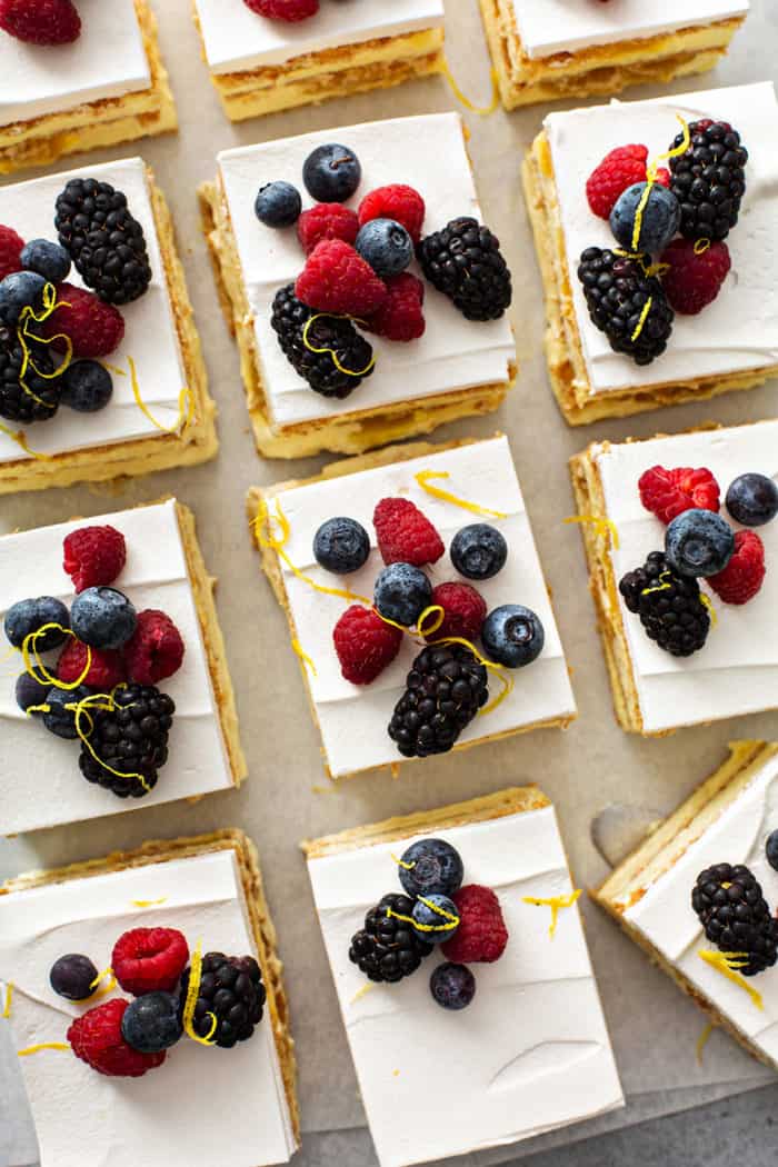 Overhead view of sliced lemon icebox cake topped with fresh berries