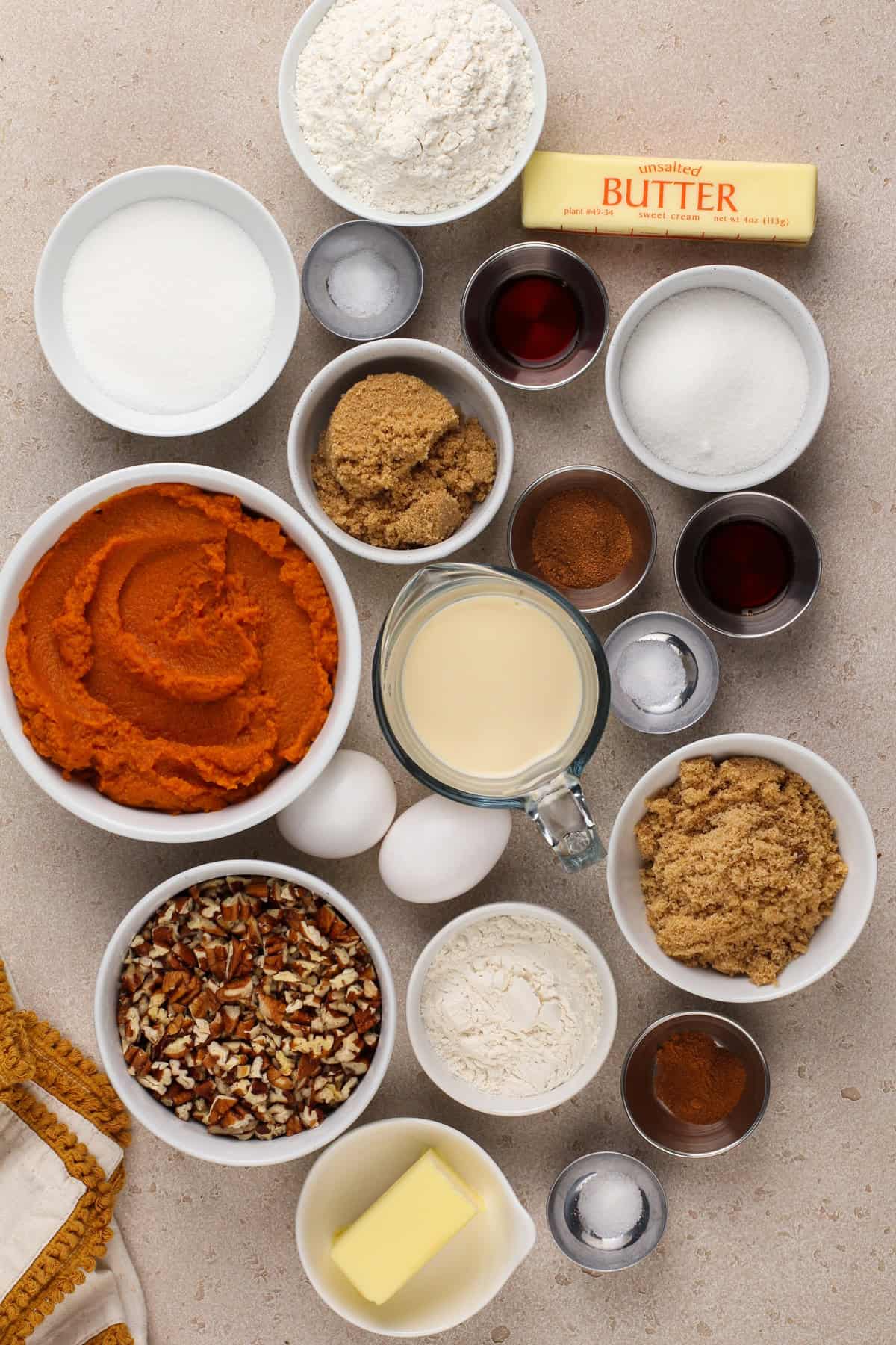 Ingredients for pumpkin pecan pie bars arranged on a countertop.