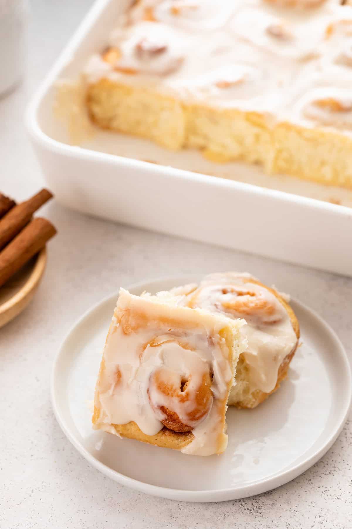 Two mini cinnamon rolls on a white plate.