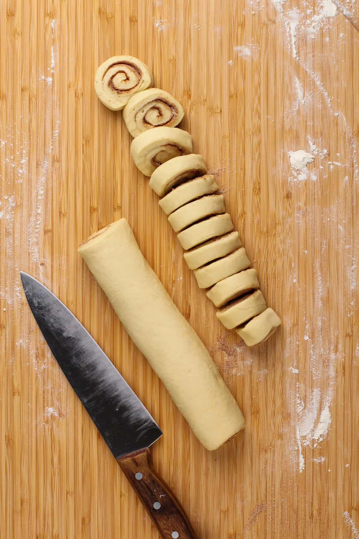 Cinnamon roll dough rolled into a log and cut into pieces.