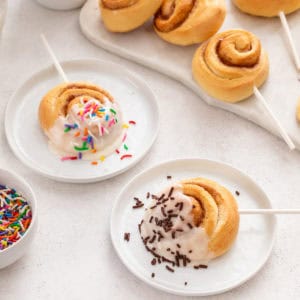 Two mini cinnamon rolls dipped in glaze and topped with sprinkles.