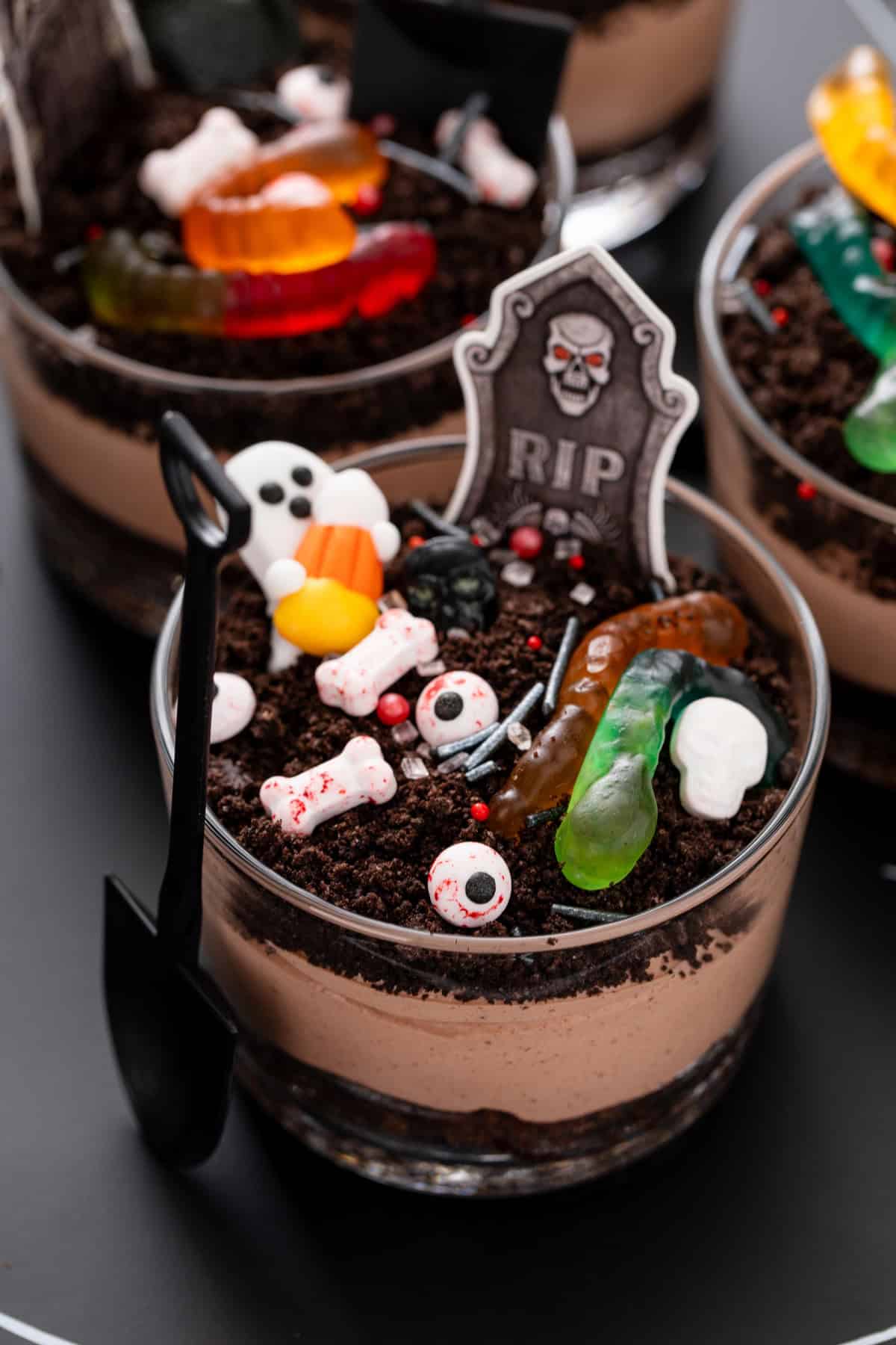 Close up of a brownie dirt pudding decorated with Halloween candies.