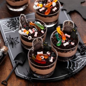 Brownie dirt pudding cups on a black platter.