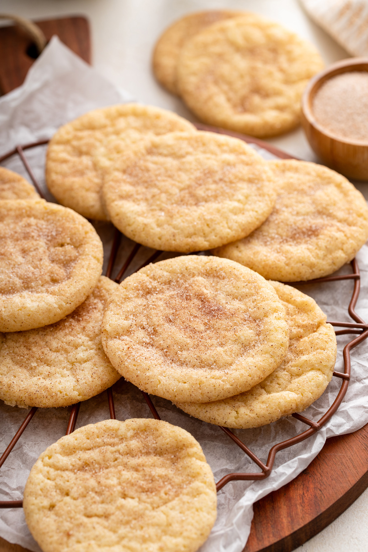 Easy snickerdoodle cookies scattered on a wire rack.