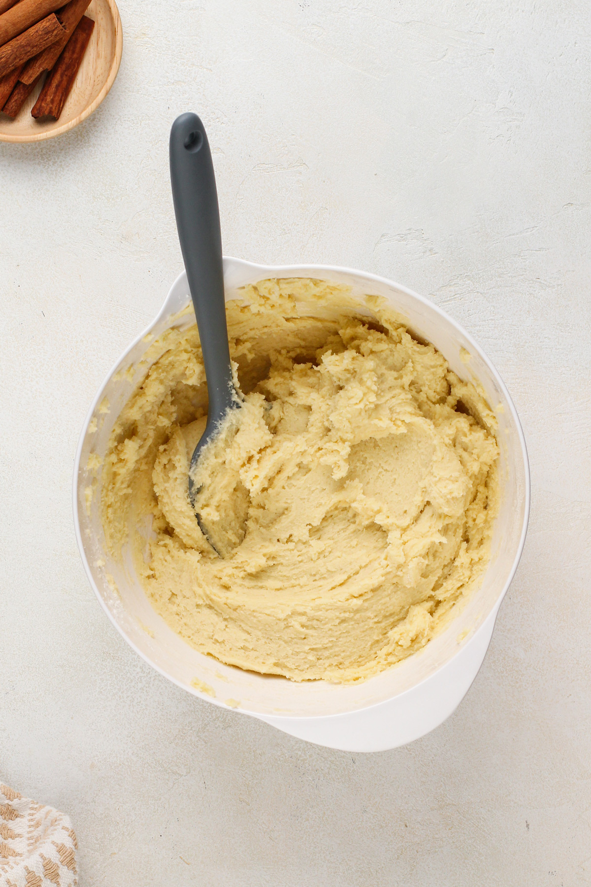 Snickerdoodle cookie dough mixed in a white bowl.