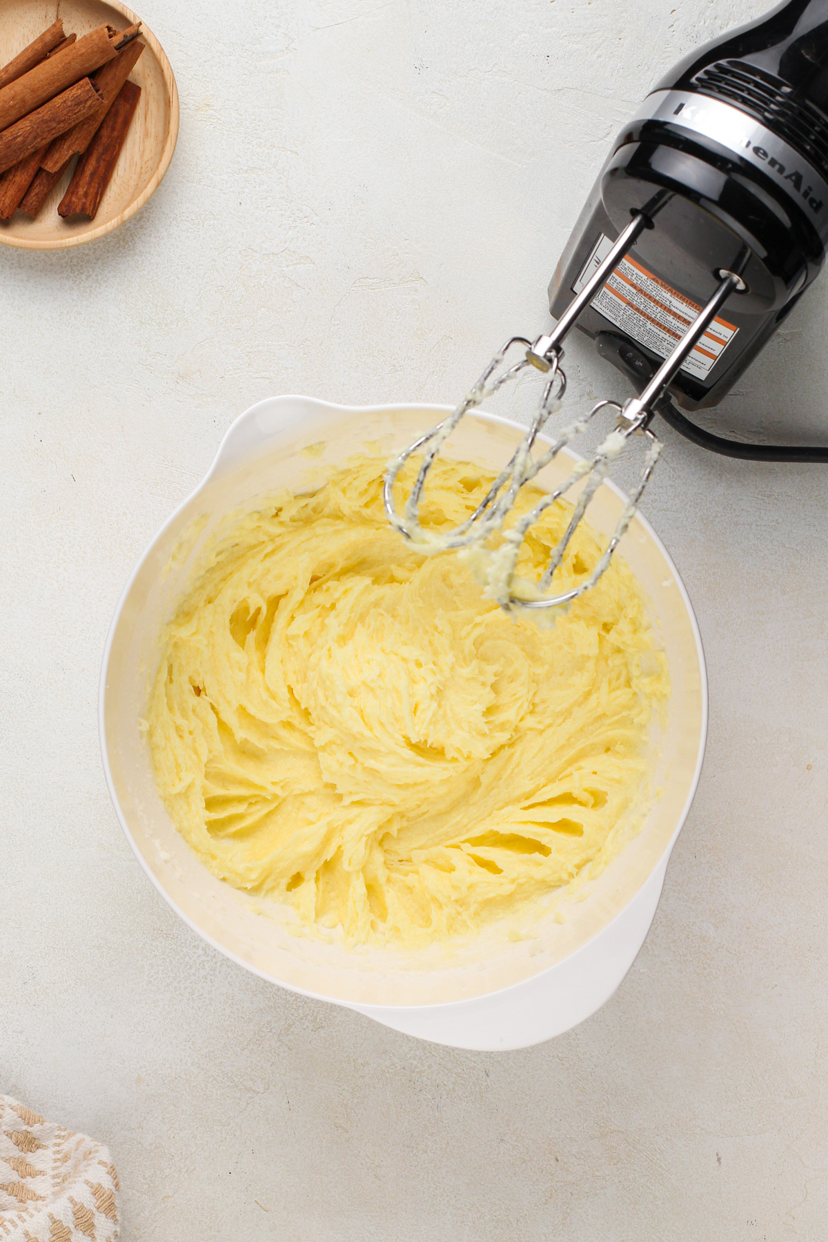 Wet ingredients for snickerdoodle cookies mixed in a white bowl.