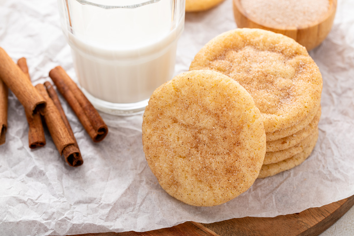 Stack of easy snickerdoodle cookies next to a glass of milk.