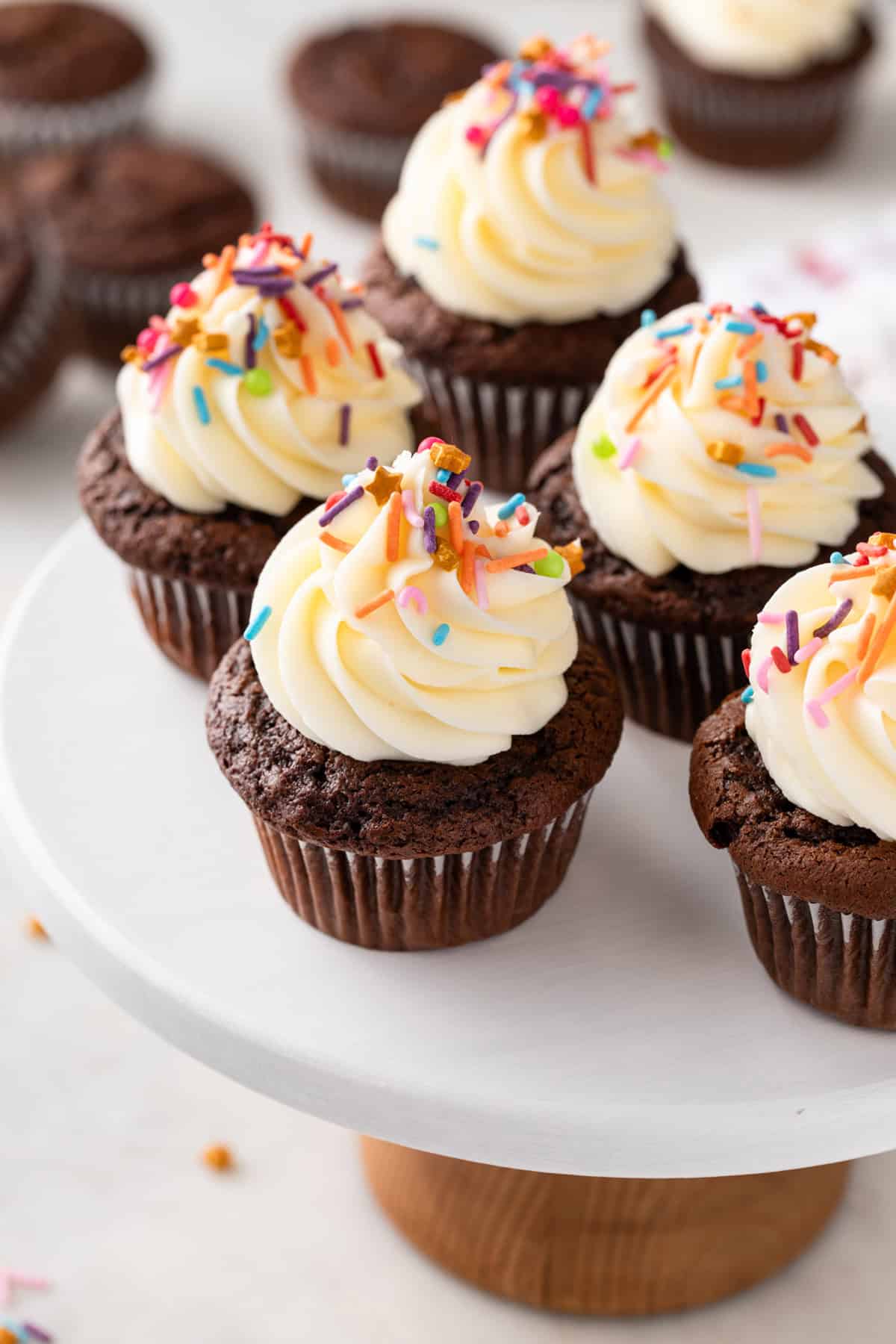 Chocolate cupcakes made with doctored cake mix arranged on a cake stand.