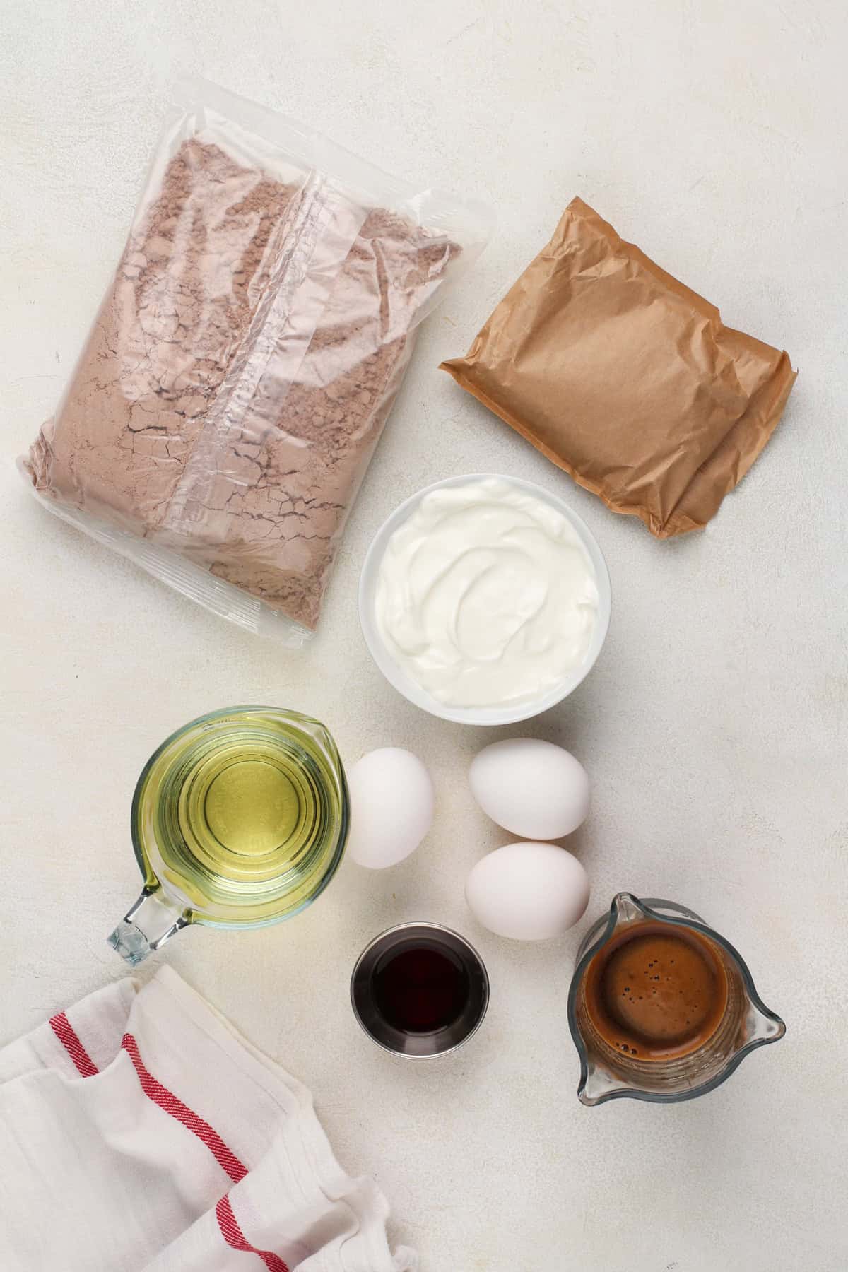 Ingredients for doctored cake mix arranged on a countertop.