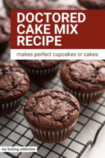 Unfrosted chocolate cupcakes made with doctored cake mix cooling on a wire rack. Text overlay includes recipe name.