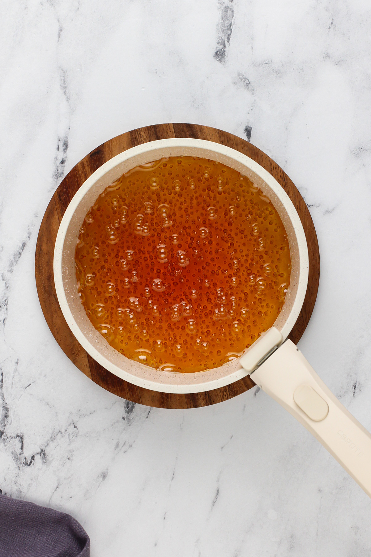 Deep amber caramel sauce in a saucepan.