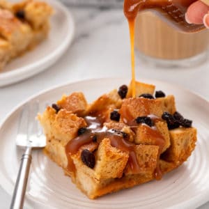 Whiskey caramel sauce being poured over irish bread pudding.