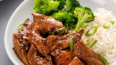 Honey soy chicken in a bowl with rice and broccoli.