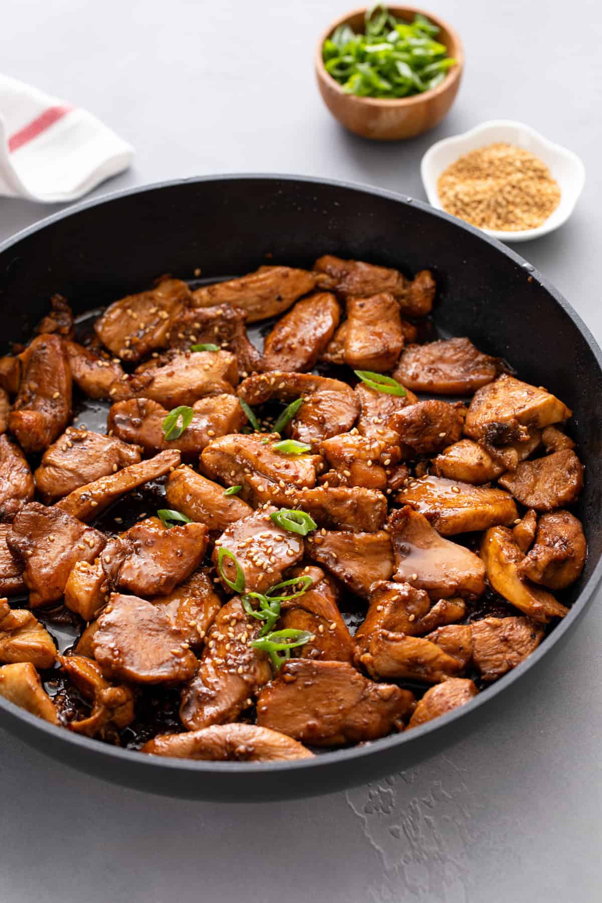 Honey soy chicken in a black skillet.