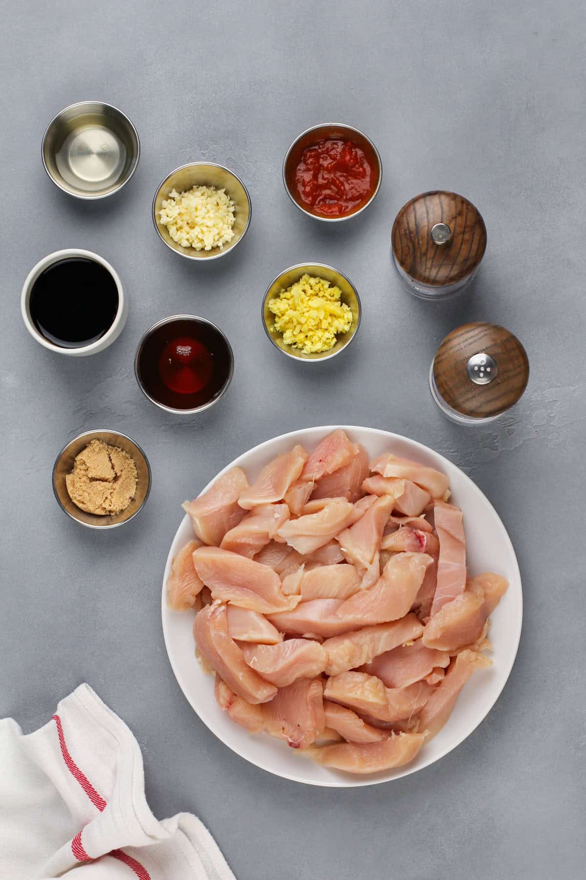 Ingredients for honey soy chicken arranged on a gray countertop.